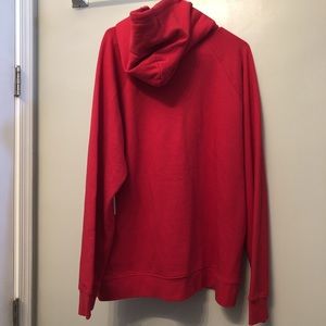 Red OBEY sweatshirt.